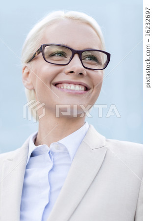 young smiling businesswoman over office building young smiling businesswoman over office building 16232697