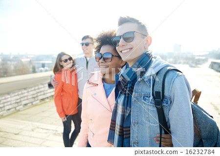 happy teenage friends in shades hugging on street happy teenage friends in shades hugging on street 16232784