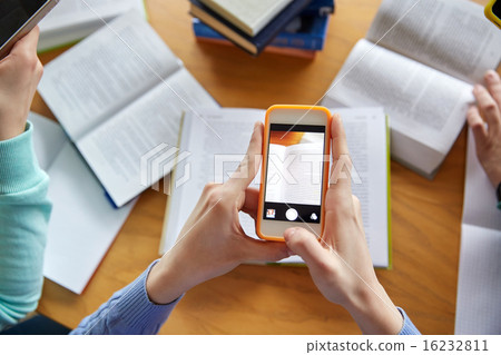 students with smartphones making cheat sheets students with smartphones making cheat sheets 16232811
