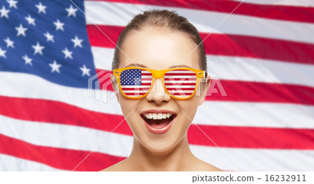 happy teenage girl in shades with american flag 16232911
