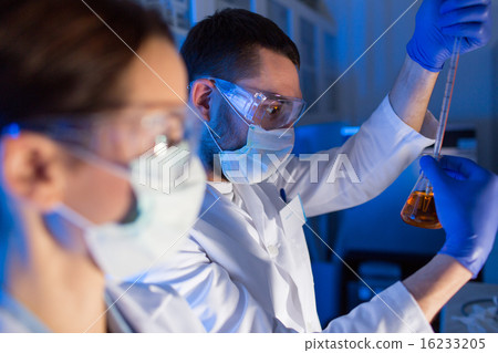 close up of scientists making test in lab 16233205