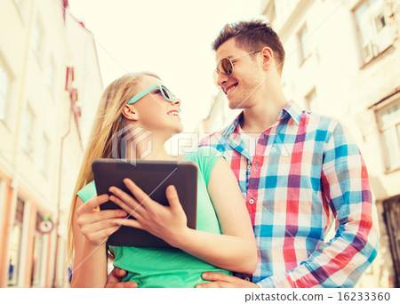 smiling couple with tablet pc in city smiling couple with tablet pc in city 16233360