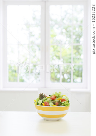 A salad placed on a table 16235228