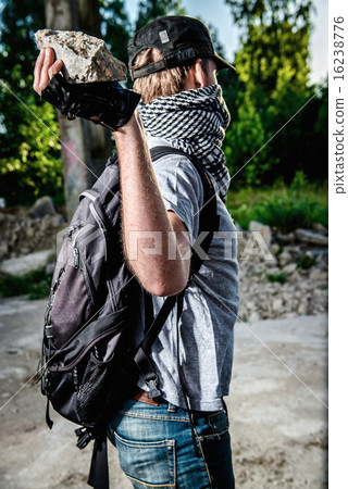 Man holding big stone in a hand 16238776