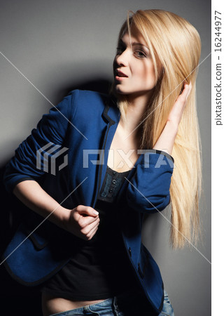 Posing blond woman with long hair on grey 16244977