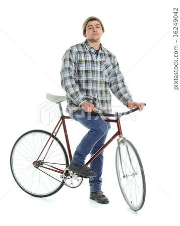 Young man doing tricks on fixed gear bicycle on a white Young man doing tricks on fixed gear bicycle on a white 16249042