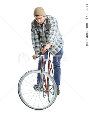 Young man doing tricks on fixed gear bicycle on a white Young man doing tricks on fixed gear bicycle on a white 16249044