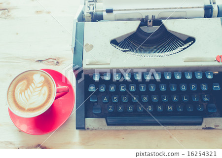 Latte art in red coffee cup and Typewriter  16254321