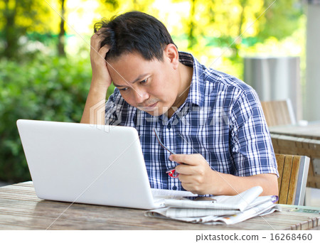 Stress Asian man looking at laptop. Stress Asian man looking at laptop. 16268460