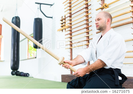 Man at Aikido martial arts with wooden sword 16271075