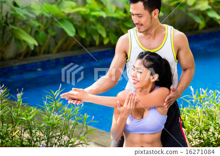 Asian woman with trainer at fitness workout 16271084