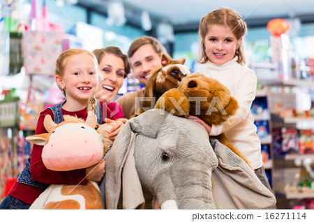 Family with stuffed elephant in toy store playing Family with stuffed elephant in toy store playing 16271114