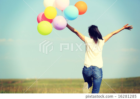 young asian woman with colored balloons young asian woman with colored balloons 16281285