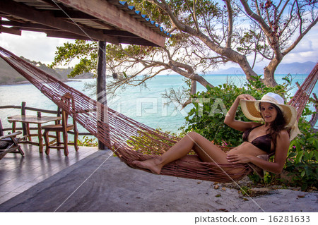 Woman posing at romantic hammock in private house near tropical beach 16281633