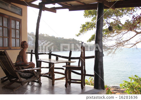 Young attractive woman sitting at the turist resort 16281636