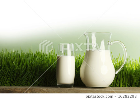 Glass of milk and jar on meadow Glass of milk and jar on meadow 16282298