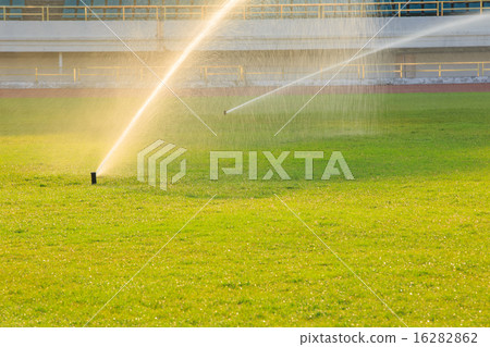 automatic watering system on green grass automatic watering system on green grass 16282862