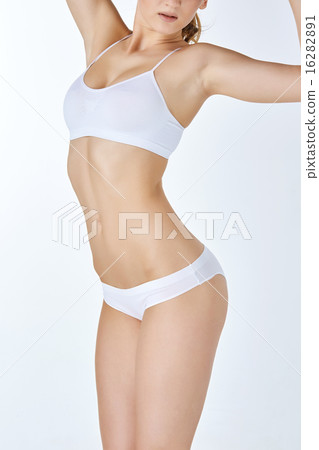 Young, slim, healthy and beautiful woman in white swimsuit  16282891