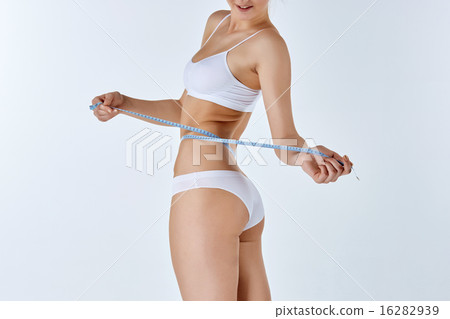 Woman holding meter measuring perfect shape of her beautiful body Woman holding meter measuring perfect shape of her beautiful body 16282939