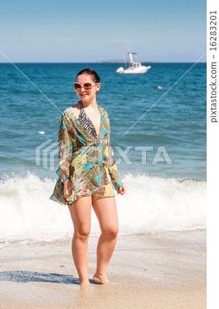 woman walking away on the beach 16283201
