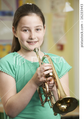 Girl Learning To Play Trumpet In School Music Lesson Girl Learning To Play Trumpet In School Music Lesson 16283443