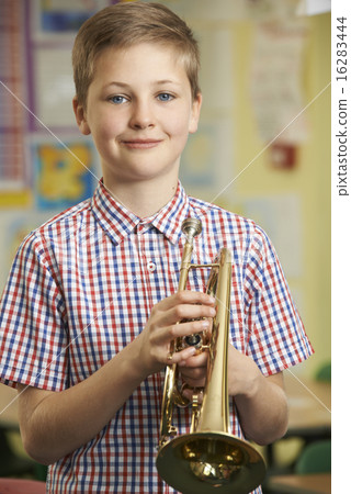 Boy Learning To Play Trumpet In School Music Lesson Boy Learning To Play Trumpet In School Music Lesson 16283444