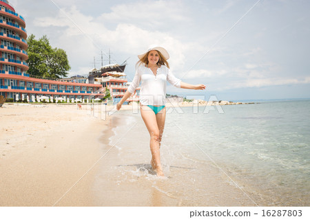 joyful woman walking on the beach at sunny day joyful woman walking on the beach at sunny day 16287803