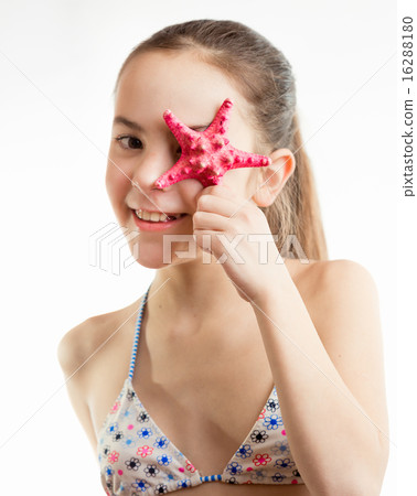 Portrait of happy smiling girl holding starfish 16288180