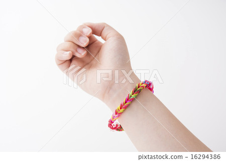 Hand of a girl who puts on a ring rubber Misanga 16294386