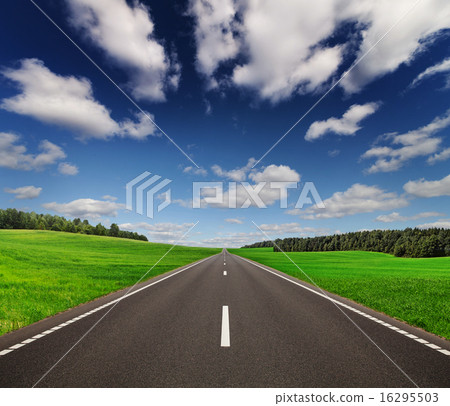 Road under beautiful sky between green hills 16295503