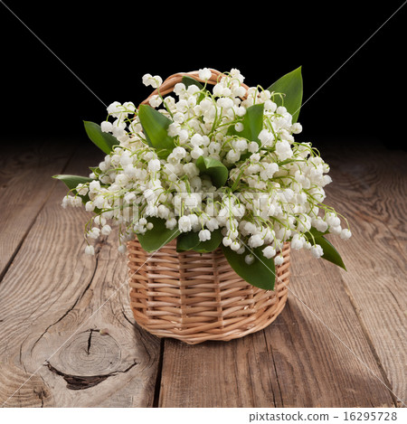 Bouquet of lilies of the valley on the old board 16295728