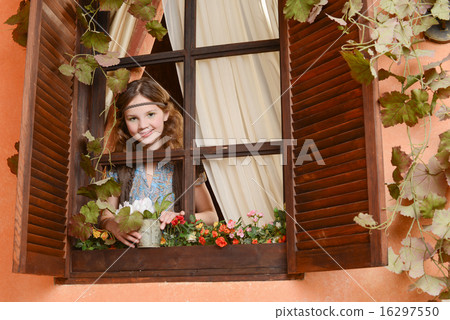 Young girl near the window Young girl near the window 16297550