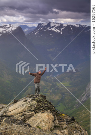 Happy man on the top of a high mountain Happy man on the top of a high mountain 16297563