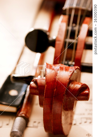 Close Up of Violin and Bow Resting on Sheet Music Close Up of Violin and Bow Resting on Sheet Music 16300390