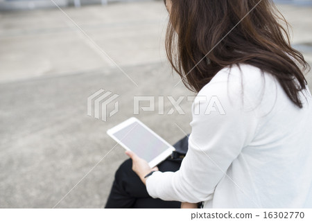 Women who use tablets outdoors Women who use tablets outdoors 16302770