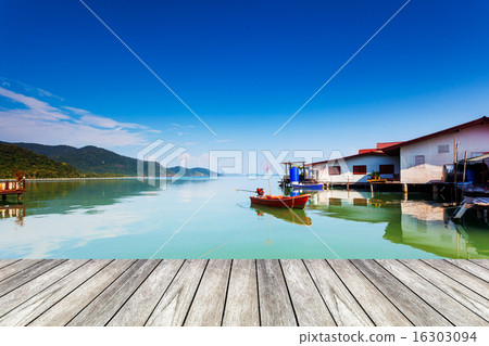 wood bridge and orange boat on sea wood bridge and orange boat on sea 16303094