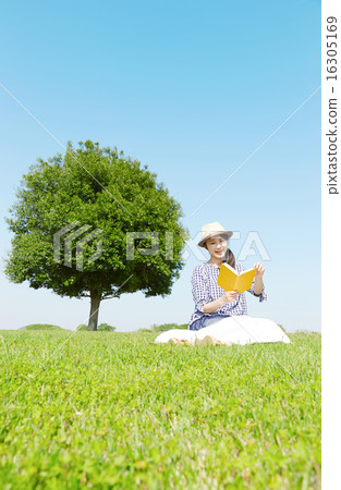 A woman reading a book in the square A woman reading a book in the square 16305169