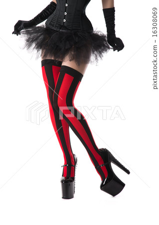 Burlesque woman dressed in striped stockings, corset and mini sk 16308069
