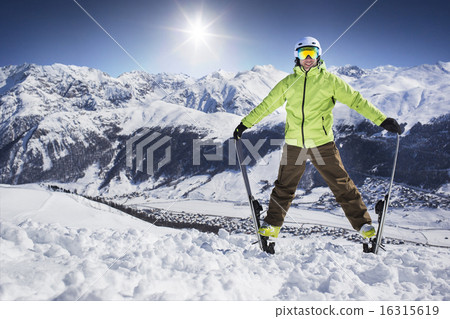 Young men on skies in winter mountain resort 16315619
