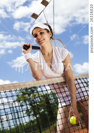 Girl playing tennis on the court 16316810