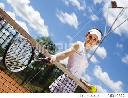 Girl playing tennis on the court 16316812