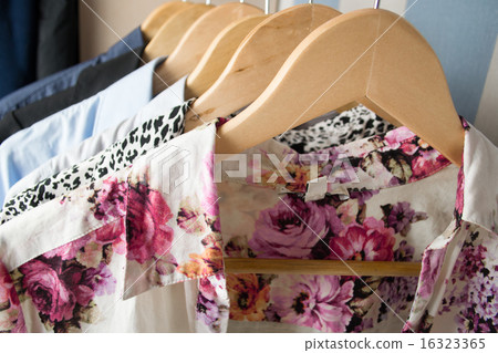 Different clothes on hangers close up 16323365
