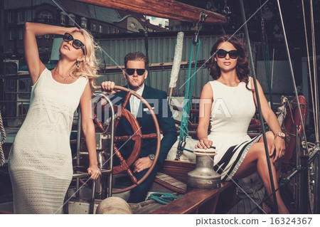 Stylish wealthy friends on a luxury yacht 16324367