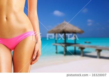 Woman on beautiful beach with jetty 16328007