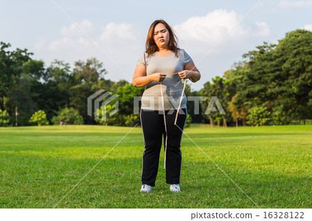 Obese woman is worrying about her overweight. Obese woman is worrying about her overweight. 16328122