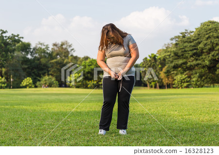 Obese woman is worrying about her overweight. Obese woman is worrying about her overweight. 16328123