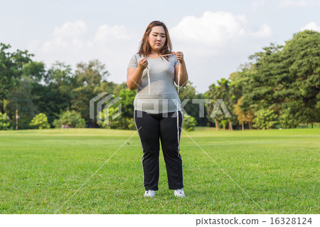 Obese woman is worrying about her overweight. Obese woman is worrying about her overweight. 16328124