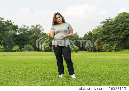 Obese woman is worrying about her overweight. Obese woman is worrying about her overweight. 16328125