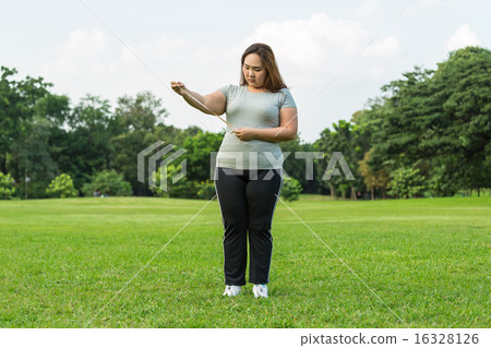 Obese woman is worrying about her overweight. 16328126