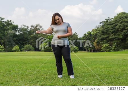 Obese woman is worrying about her overweight. Obese woman is worrying about her overweight. 16328127